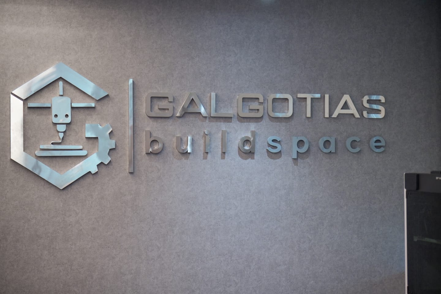 Brushed metal Galgotias Buildspace sign